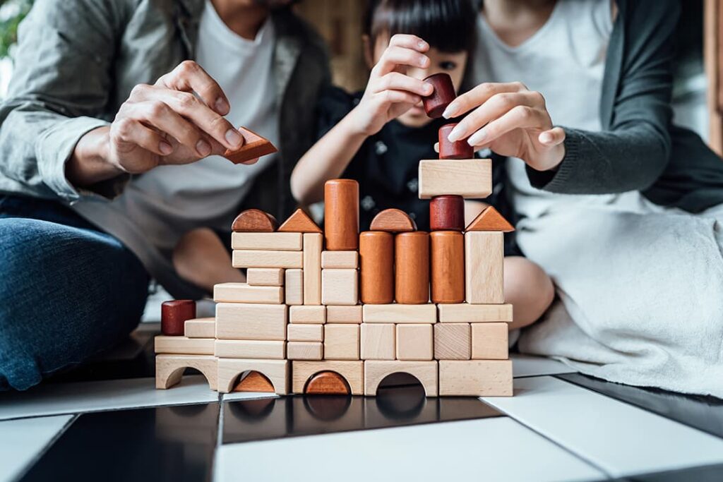 family of three. stacking small toy blocks